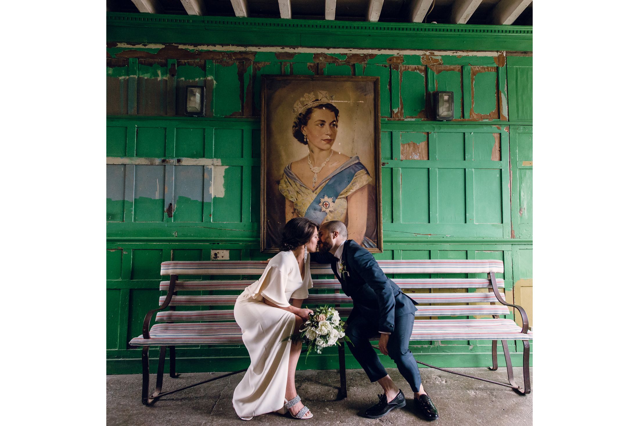 Bride and Groom Kissing on a bench in London